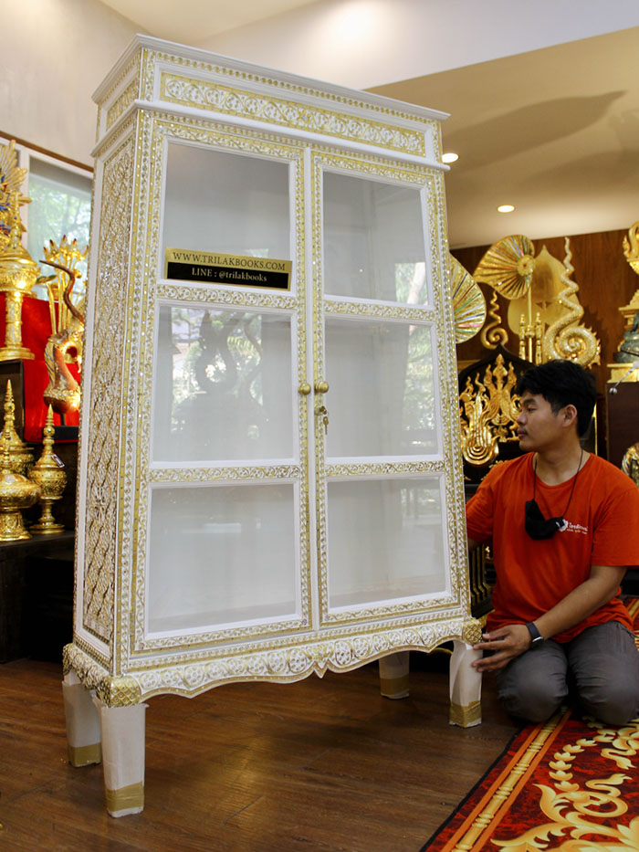 ตู้พระไตรปิฎกสีขาว ลวดลายทอง

ด้านบนของตู้เป็นจั่ว และ ประดับลวดลายทอง ตลอดทั้งหลัง 
และประดับด้วยกระจกสี อย่างปราณีต และงดงาม 